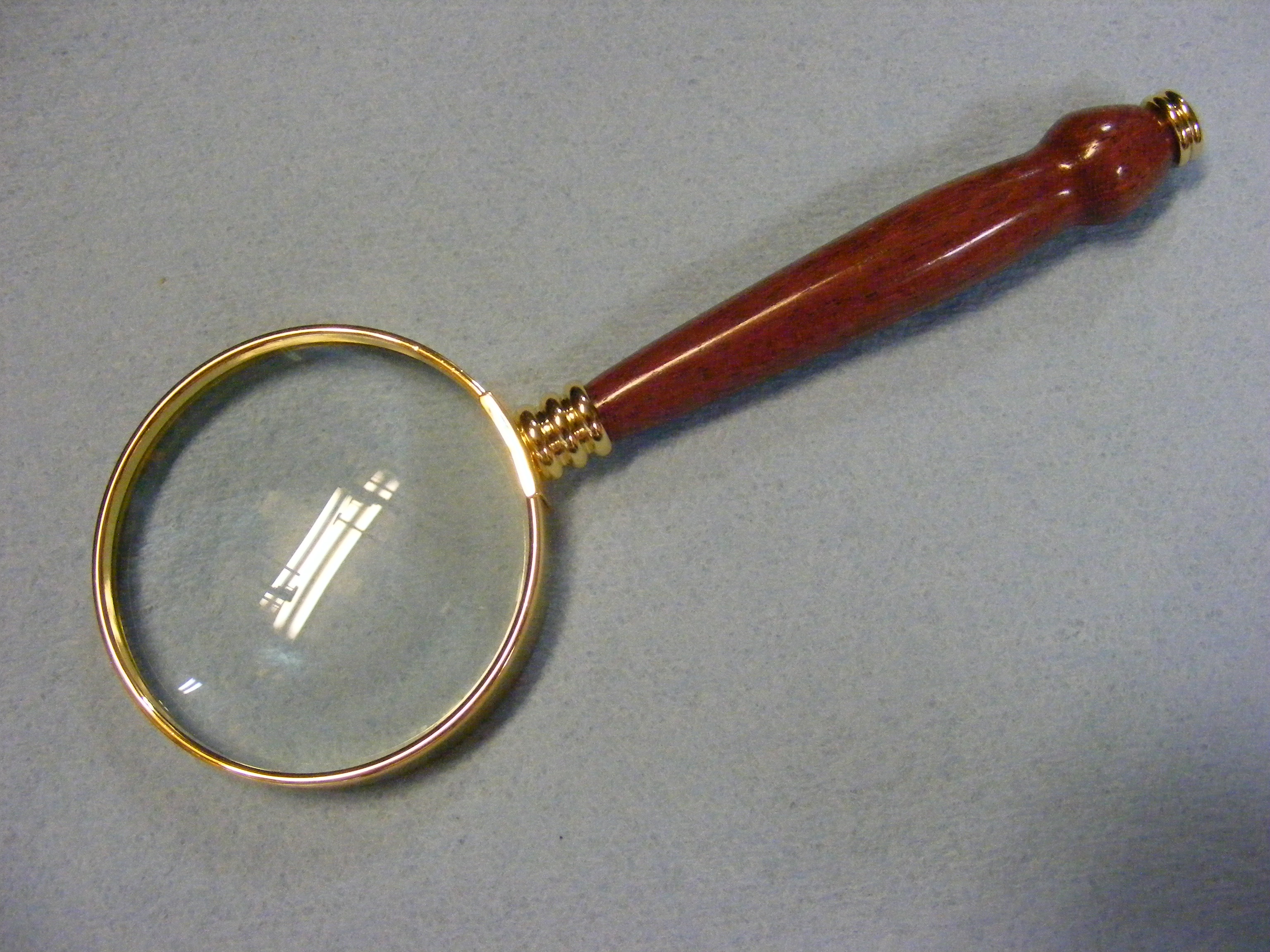 A wooden board and steel made vintage style magnifying glass, complete  handmade, made by artisians High